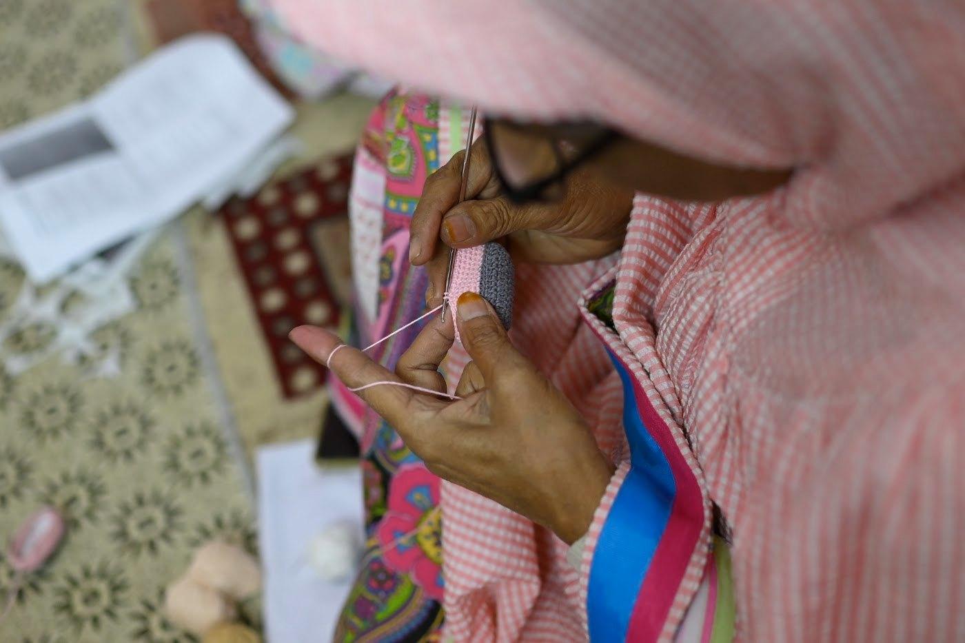 An artisan working with hook and thread